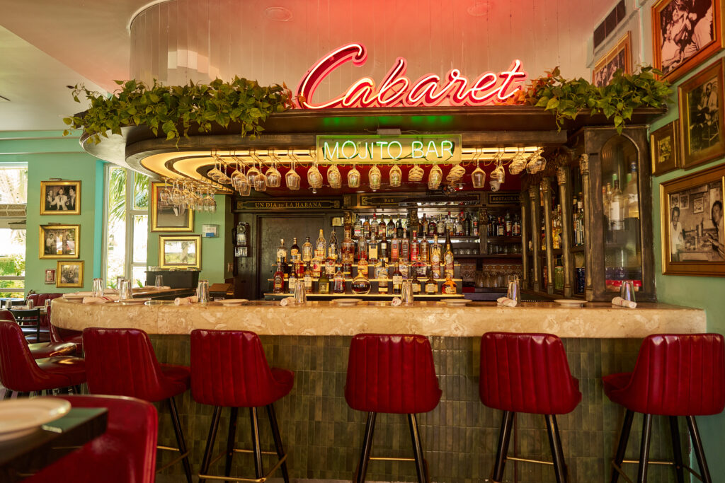 Classic mojito bar with neon lights at Havana 1957, creating a romantic and vibrant atmosphere for dinner on Española Way